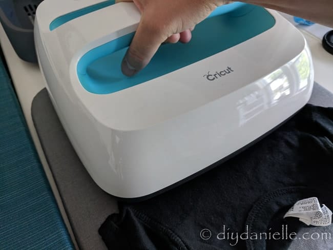 Using the Cricut EasyPress on a Diaper Duty shirt.