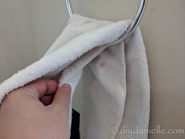 Stud snap placed inside a hand towel, hidden from sight.
