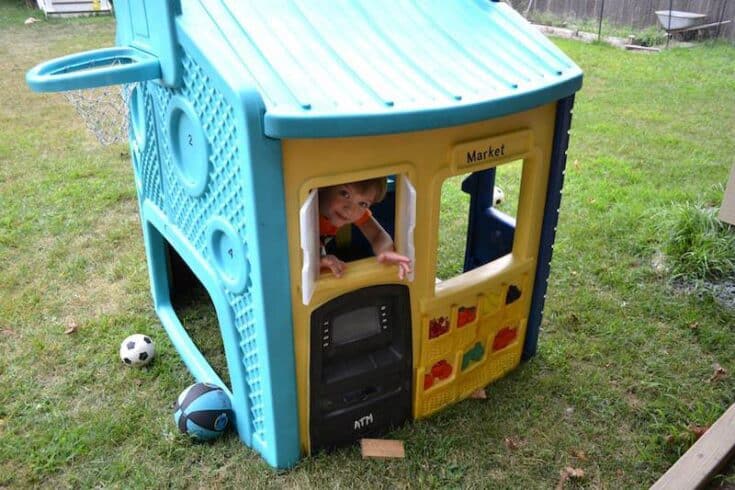 Kids space with a painted plastic playhouse.