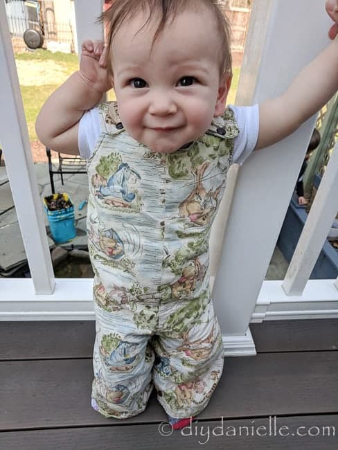 Baby wearing the reversible romper that I made in size 12-18 months. Winnie the Pooh fabric.