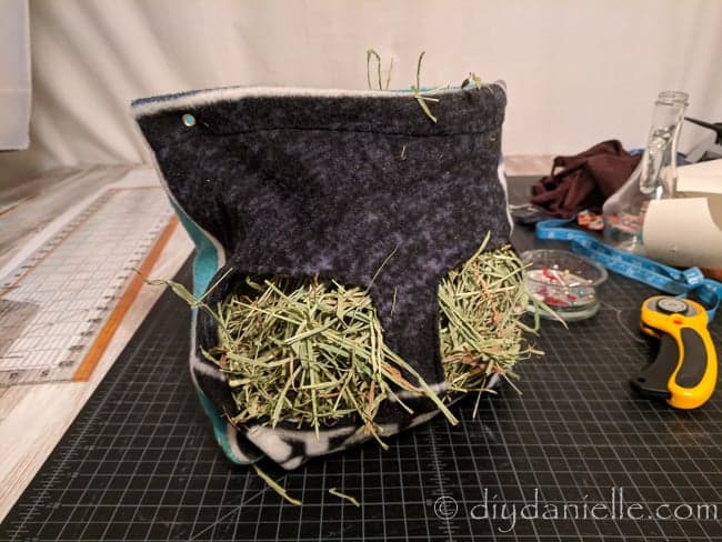 Hay bag for guinea pigs. The feeding area is big enough that the guinea pigs can crawl in and fuss around in the hay.