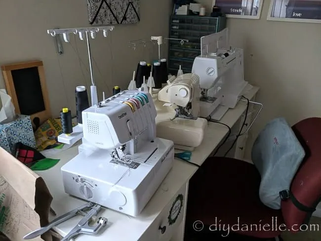 The sewing area without the muffling mat under the serger and other machines.