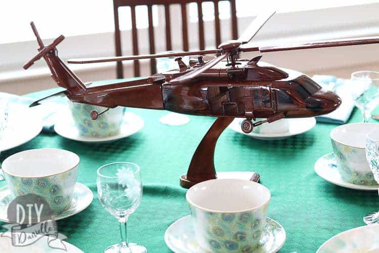 Wood Black Hawk Helicopter replica as a centerpiece on the table.