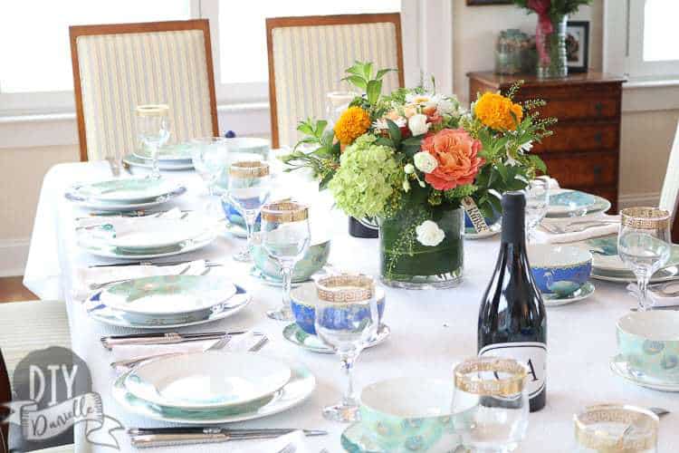 The table setup with peacock themed dishware.