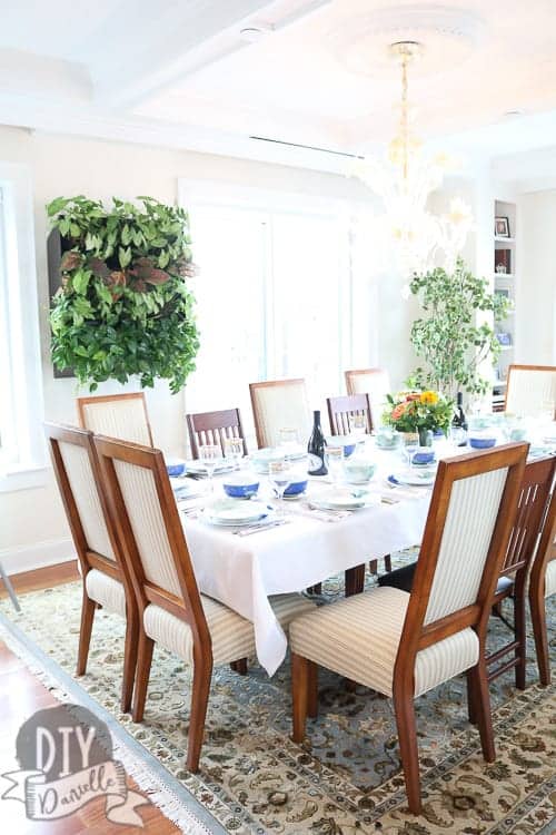 Table set for the big Italian dinner. Love the lighting in this room and the live plants.