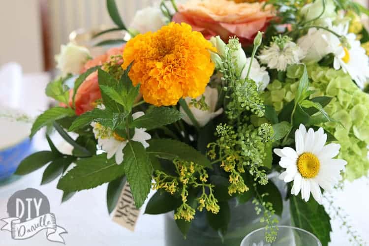 Gorgeous floral arrangement for the dinner table. This really added extra color to a table that was mostly blues before. The green leaves tie it altogether.