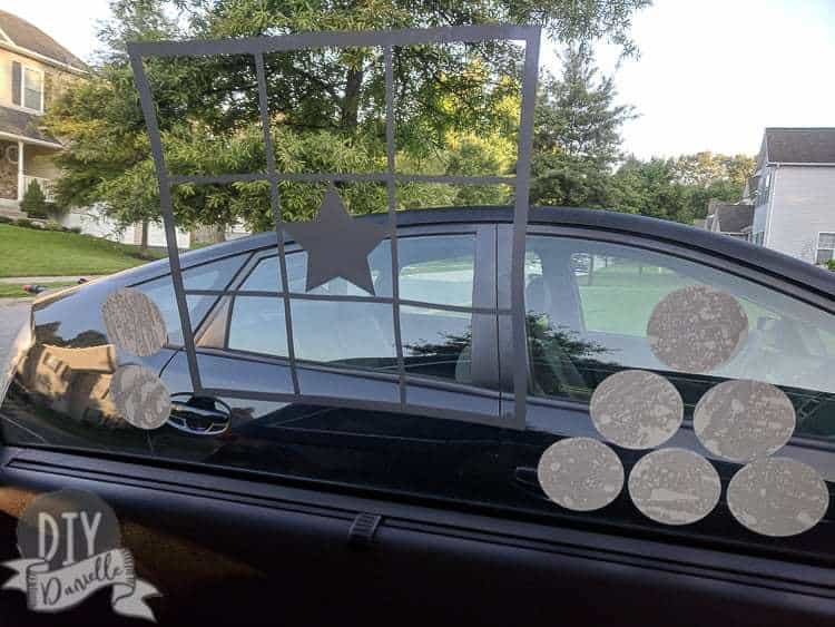 Window cling in the shape of a Bingo board. The white circles are the chips, but you could just use a dry erase marker too.