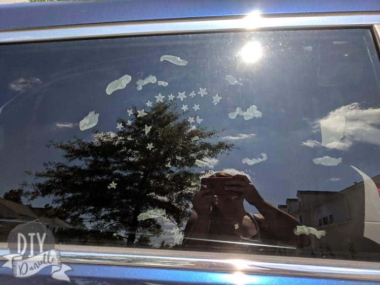 Stickers on a car window, photo taken from outside the car.