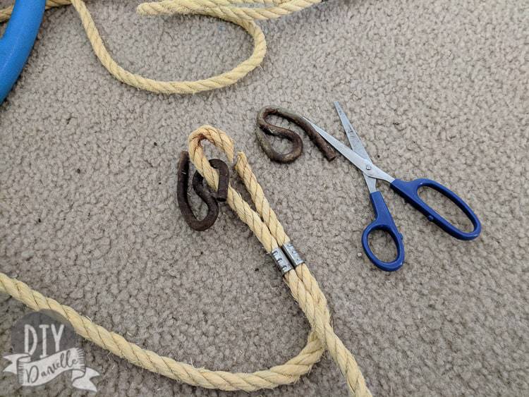 Cutting away the old rope and rusted hardware from a baby swing.