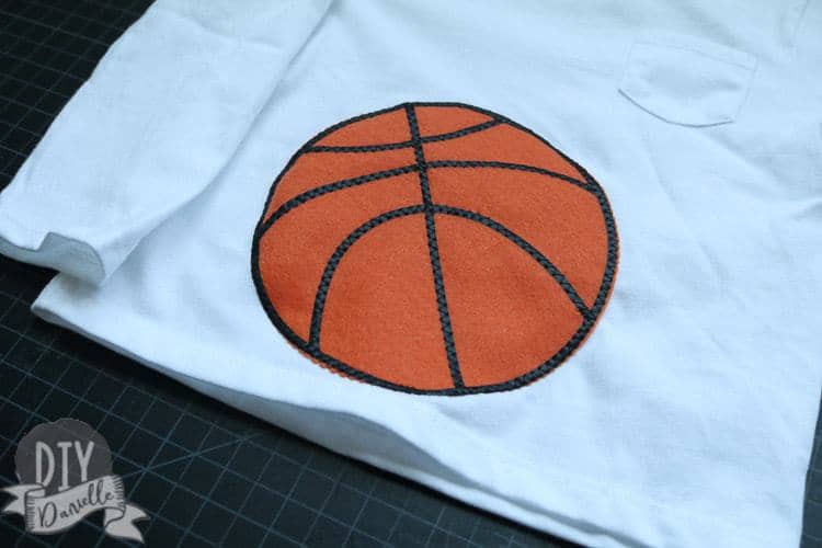 Basketball on the tummy area of baby's shirt.