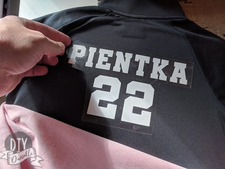 Ironing on the name and numbers for the basketball warm up jacket.