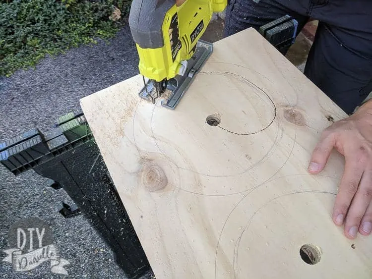 Cutting out the hole for the dog bowls with a jig saw.