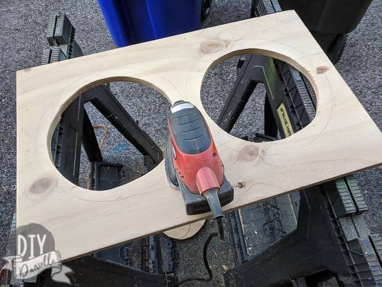 Sanding the edges of the dog feeding stand.