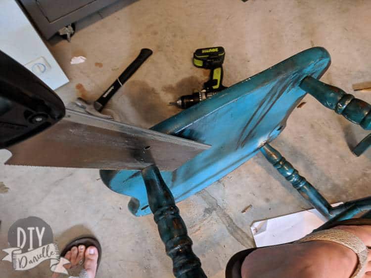 Cutting off the legs of a chair.