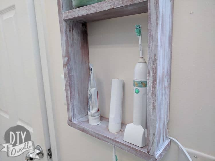 Wall mounted shelf that can hold electric toothbrushes and the charging base. Super easy DIY.