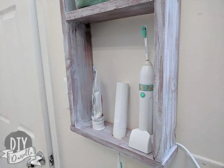 Wall mounted shelf that can hold electric toothbrushes and the charging base. Super easy DIY.