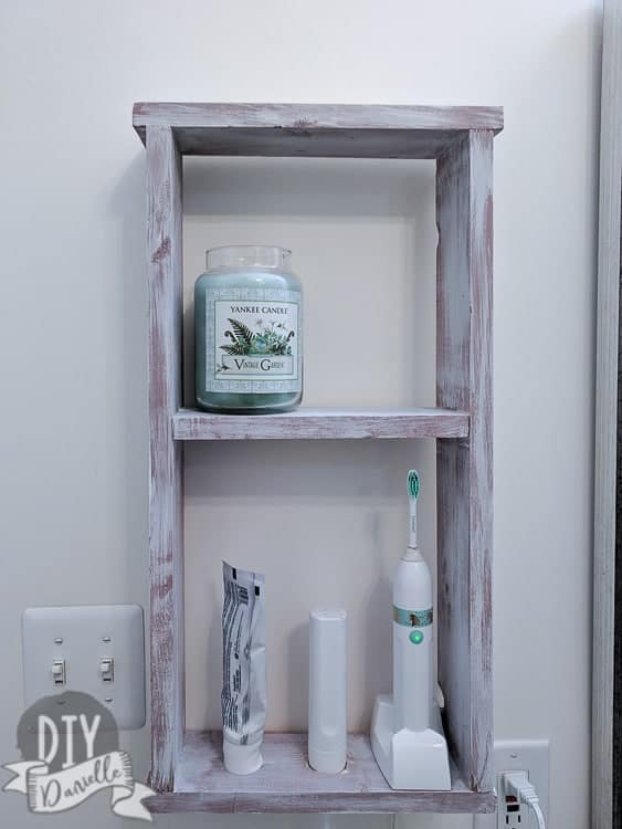Toothbrush storage idea for the bathroom. This easy to build shelf is perfect!
