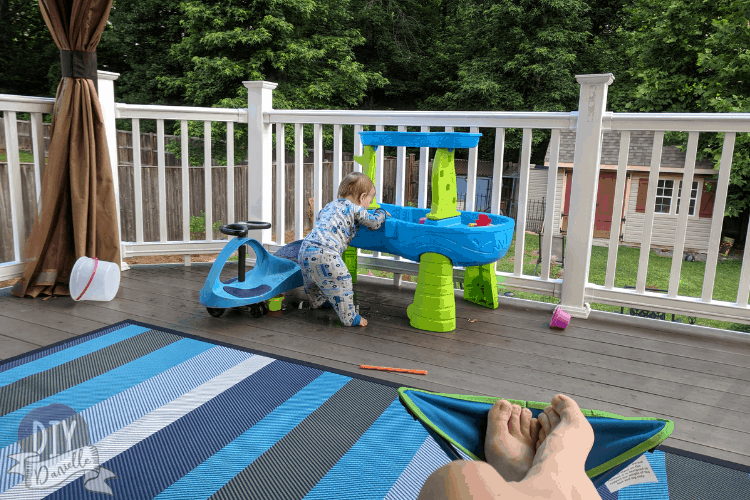 One year old playing in a water table while mommy relaxes.