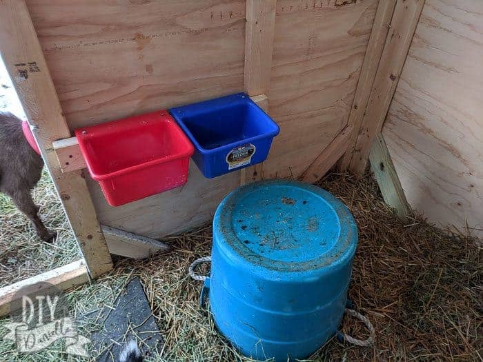 Mounted buckets for minerals on the wall of the goat house.