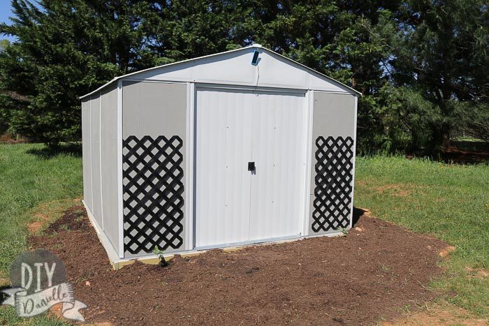Ironwood Shed Frame Kit with Exterior Wood Panels painted gray. 