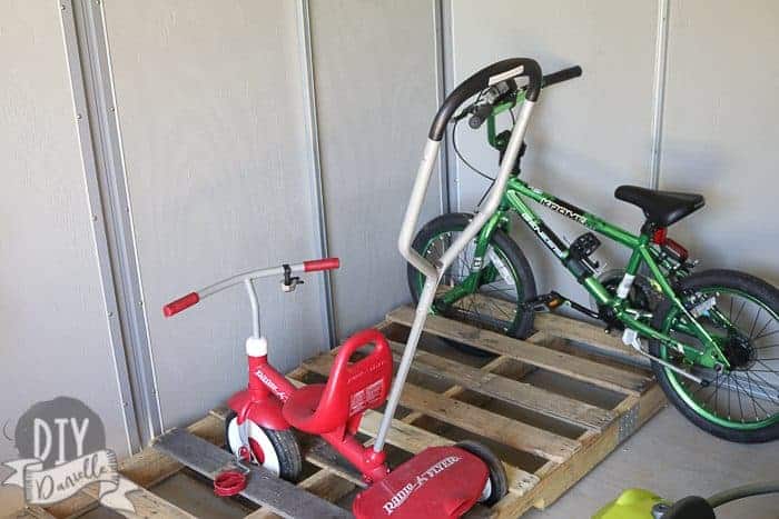 Using a pallet as a bike rack in the kids garage.