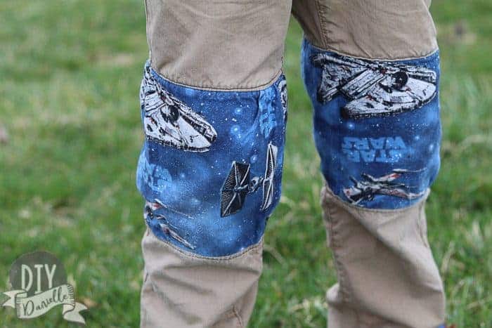 Holes in boy's pants replaced with other fabric to patch the pants.