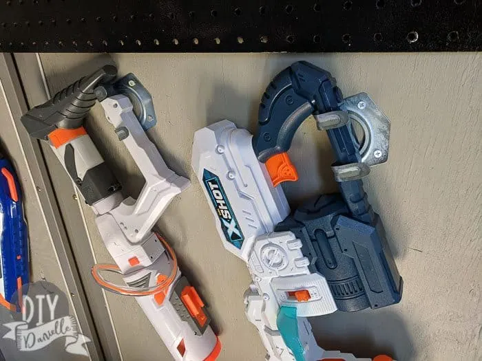 Nerf guns stored on $1 tool hooks. These are stored at an angle so they would fit.