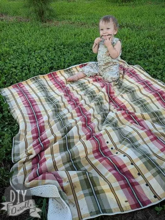 It's really easy to sew a custom picnic blanket for your family. This one has a carrying strap, snaps closed, and has toy tethers.