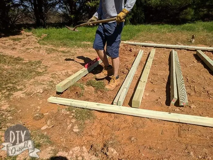 Leveling pressure treated wood for the shed base.
