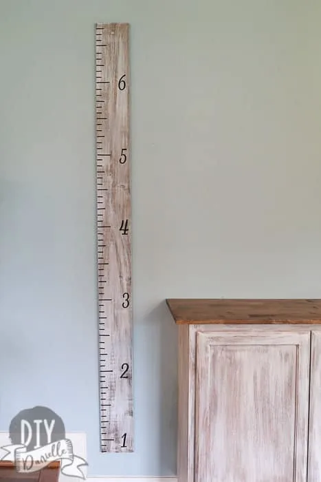 DIY wood growth ruler that matches the cabinets. This was distressed and uses vinyl. 