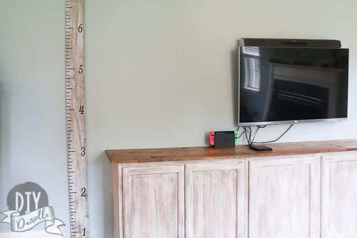 DIY Growth Chart next to matching cabinets.