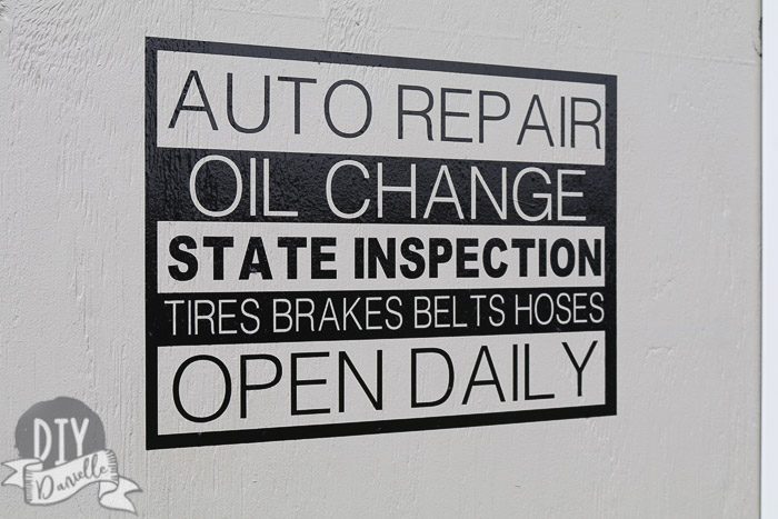 This is a decal I made with my Cricut Maker that says "Auto repair, oil change, state inspection, tires brakes belts hoses, open daily." I wanted the garage to look like an auto repair store. 