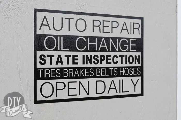 This is a decal I made with my Cricut Maker that says "Auto repair, oil change, state inspection, tires brakes belts hoses, open daily." I wanted the garage to look like an auto repair store.