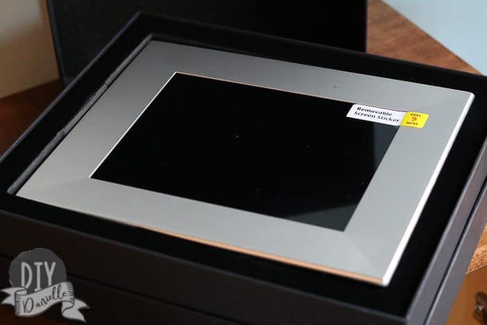 Open box, showing a new Nix Play digital photo frame.