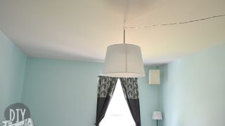 Finished DIY blackout curtains in a nursery, combining decorative fabric with blackout lining for light control and coordinated style.