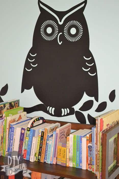 Owl decal above the bookshelves.