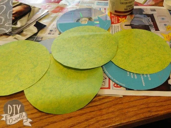 Cut out circles of scrap book paper for the CDS