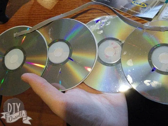 Gluing together old compact discs.