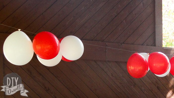 Red and white balloons upside down for Cat in the Hat party.