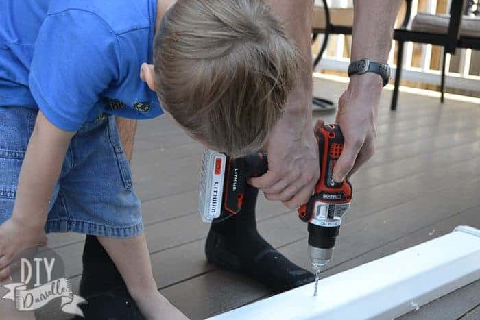 Drilling holes in the bottom of the gutters for drainage.