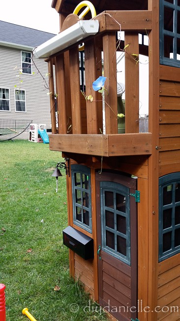 Easy DIY flower box for a play house made from a gutter.