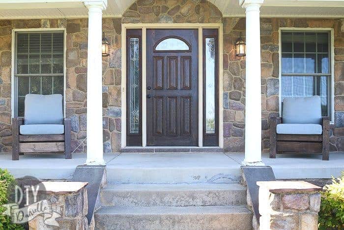 Front door and entry windows stained Cordovan Brown with matching outdoor chairs on the front porch.