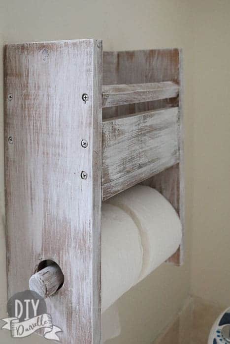 Toilet paper holder for 2 rolls, plus storage above.