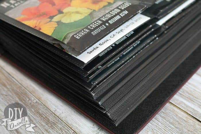 Corner of a photo album full of seed packets.