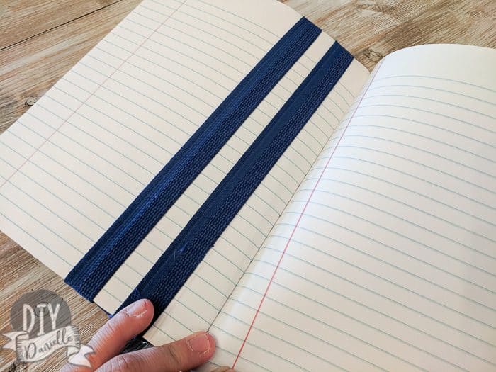 The elastic on the inside of the journal, holding the bookmark in place.