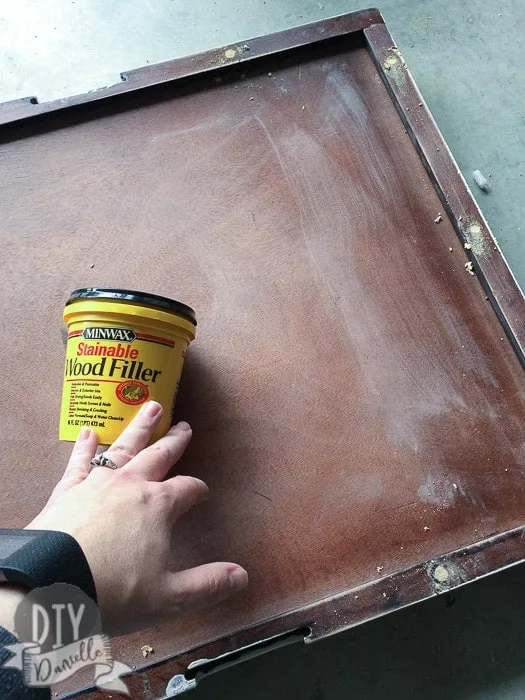 Filling the holes with stainable wood filler.