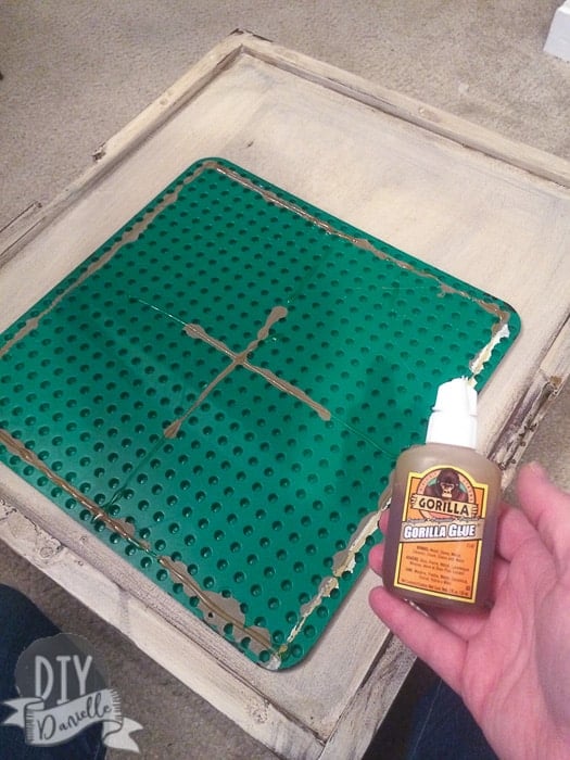 Use gorilla glue to attach your lego plate to the top of the table.