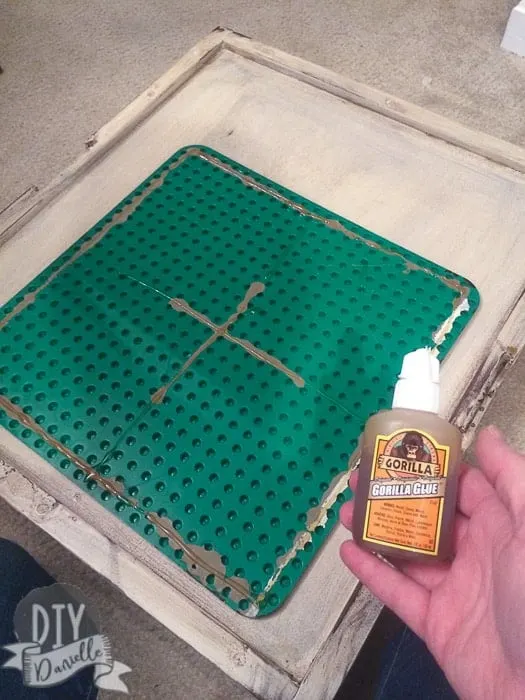 Use gorilla glue to attach your lego plate to the top of the table.