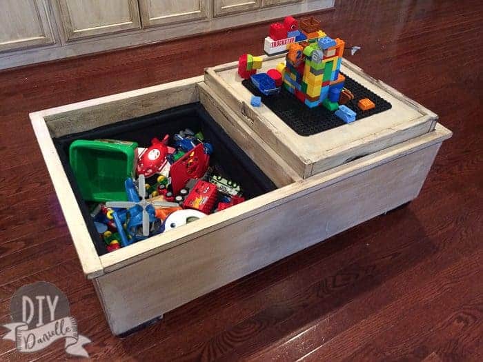 Leather storage ottoman turned into a wood toy chest and Lego table.