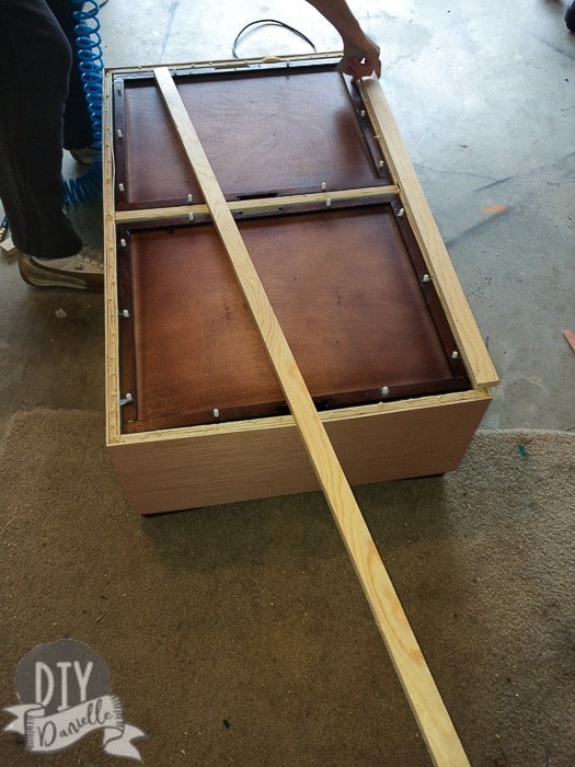 Adding a wood trim around the top of the coffee table.